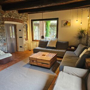 A view of the lounge at Robin's Nest Paruzzaro, Piemonte. Board games, projector and wood fire available for guest use.